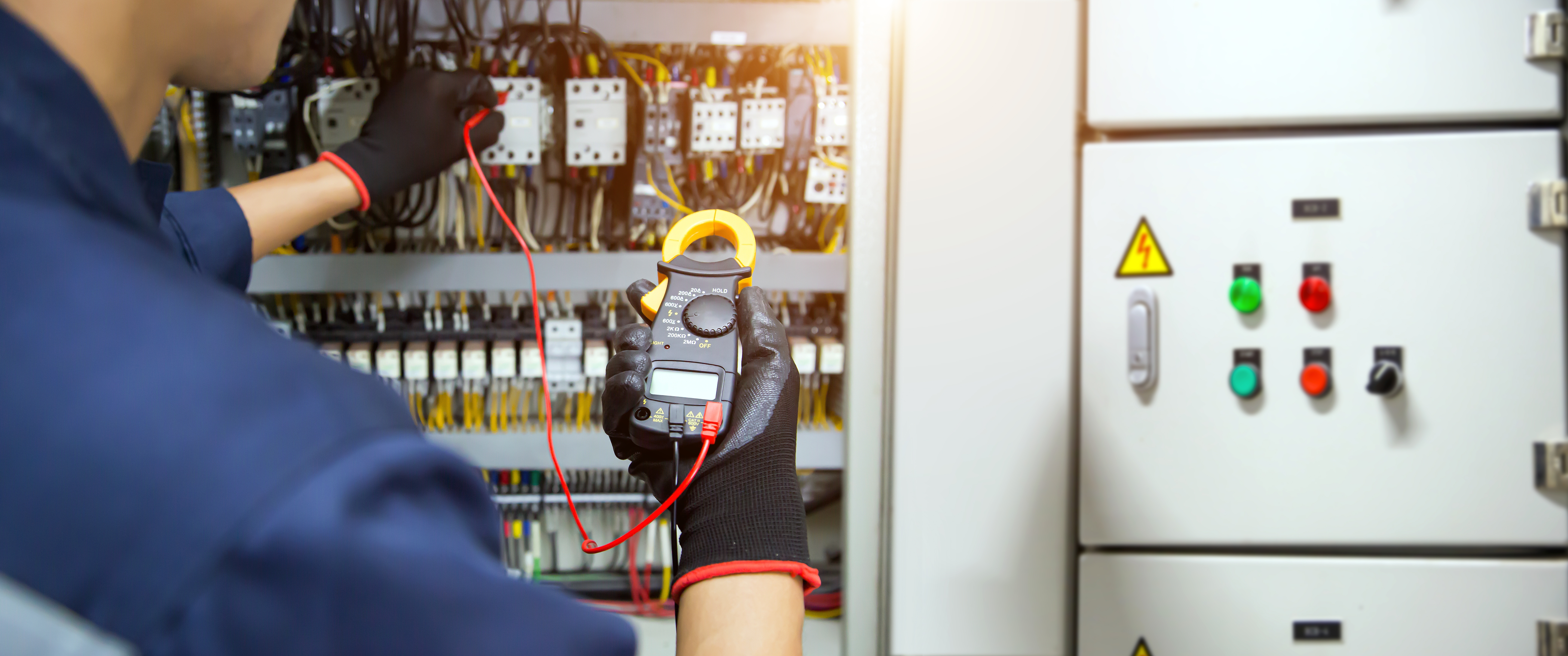 Licensed electrical contractor working on industrial switchboard installation