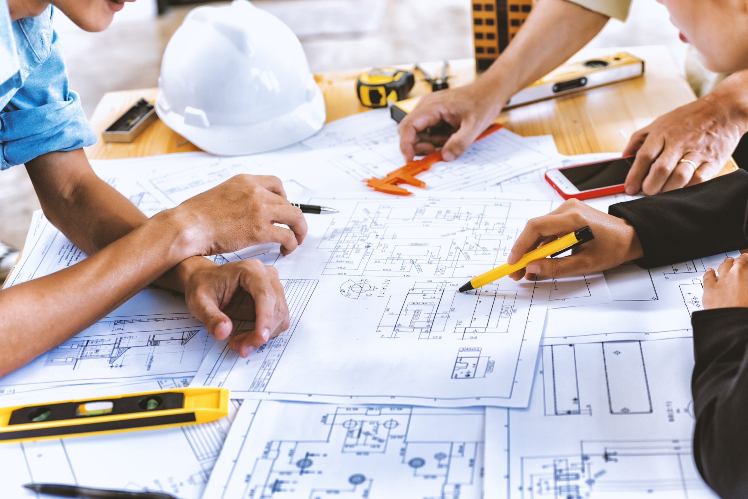 Team engineer checks construction blueprints Technically Assured Organisation